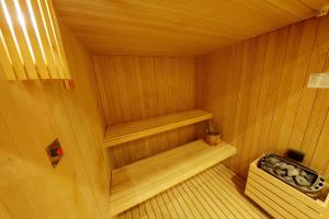 a small sauna with a bench and a sink at Casa Nostra Boutique Hotel & Spa in Palermo