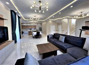 a living room with a couch and a dining room at Gabala Villa Premium in Küsnǝt