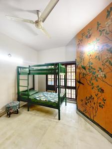 a room with bunk beds and a wall with a mural at House of Stories - Indiranagar in Bangalore