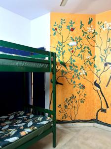 a bunk bed in a room with a wall at House of Stories - Indiranagar in Bangalore