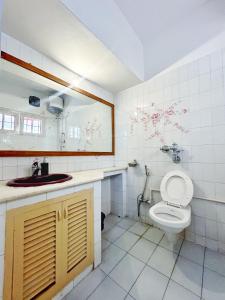 a bathroom with a toilet and a sink at House of Stories - Indiranagar in Bengaluru