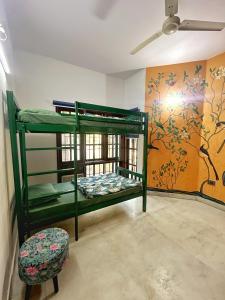a room with two bunk beds and a chair at House of Stories - Indiranagar in Bangalore