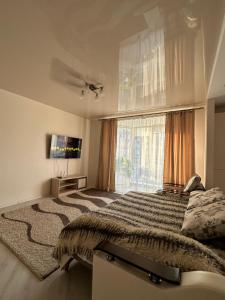 a bedroom with a large bed with a large window at 2 кімнатні Апартаменти біля Порт Сіті з кондиціонером in Lutsk