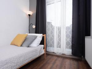 a bedroom with a bed and a window at Dietla 57, two-bedroom apartment with living room, apartment 24 , Ulysses in Krakow