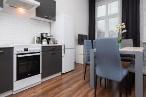a kitchen with a table and a stove top oven at Dietla 57, two-bedroom apartment with living room, apartment 24 , Ulysses in Krakow