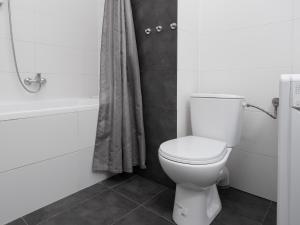 a bathroom with a white toilet and a bath tub at Dietla 57, two-bedroom apartment with living room, apartment 24 , Ulysses in Krakow