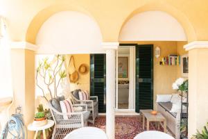 a porch with arches and chairs and a couch at Cozy Mallorca! in Palma de Mallorca