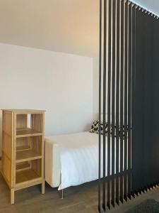 a bedroom with a bed and a book shelf at Studio bord de Creuse in Argenton-sur-Creuse