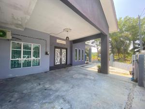 an empty garage with a large glass door at Humayyah Homestay in Sungai Besar
