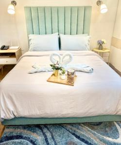 a bedroom with a large bed with a tray with gloves at 119 Amani Grand Mactan Resort in Mactan