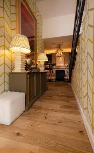 a hallway with two lamps and a white couch at Vmaison Brera Milano in Milan