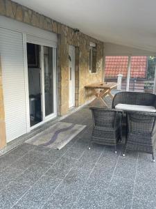 a patio with two chairs and a table and a table at Kadmi in Njeguši +10 photos