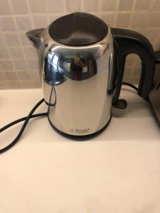 a black and white tea kettle sitting on a counter at Kensal Green - Garden Retreat in London