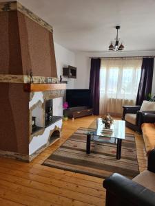 a living room with a living room with a fireplace at Casa Nico in Coşna
