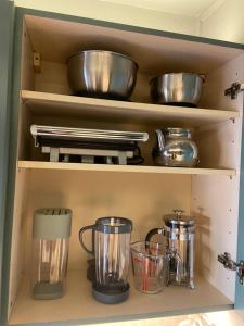 a cupboard filled with pots and pans at Kensal Green - Garden Retreat in London