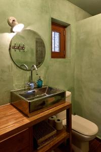 a bathroom with a sink and a toilet at Cap de Creus : bungalow, jardin y vista al mar. in Selva de Mar