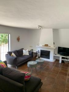 a living room with a couch and a fireplace at Villa Itaca in Mijas