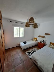 a bedroom with two beds and a window and lights at Villa Itaca in Mijas +84 photos