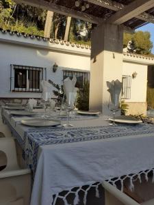 a table with a blue and white table cloth at Villa Itaca in Mijas