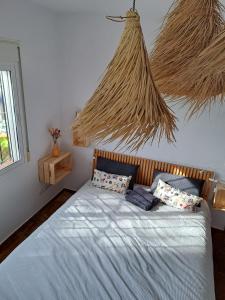 a bedroom with a bed with a bunch of straw at Villa Itaca in Mijas