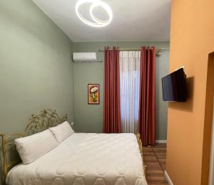 a bedroom with a bed and a television in it at HOTEL VILA 15 - CENTER in Tirana