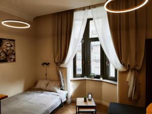 a small bedroom with a bed and a window at New luxury apartment in the center in Rīga
