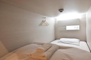 Postel nebo postele na pokoji v ubytování Hotel Tomariya Ueno