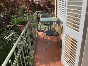 un pequeño balcón con mesa y 2 sillas en Villa Dina, en Candelo