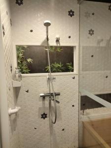 a shower with a glass door in a bathroom at 秋桜館Cosmos in Kyoto