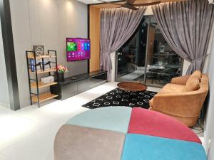 a living room with a couch and a television at Central Park 5min Angsana Mall JCHome By MWM in Johor Bahru