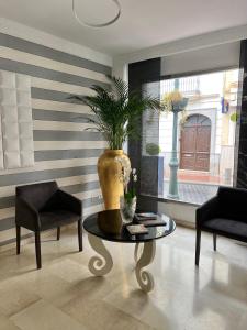 a living room with a table and a vase at Abril Nerja in Nerja