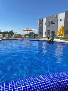 a man and a child in a swimming pool at Maison des Oliviers, Yasmine Hammamet, Bouficha in Hammamet Sud