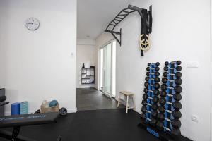 a room with a gym with a rack of dumbbells at Apartments Villa Mili in Brela