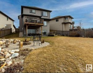 a house with a deck and a yard at Best home with lake view in Edmonton