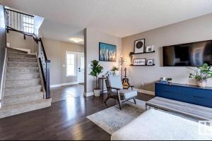 een woonkamer met een trap en een tv bij Best home with lake view in Edmonton