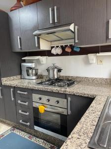 a kitchen with a stove and a counter top at RICO FLORES PALM BENSLIMANE in Mohammedia