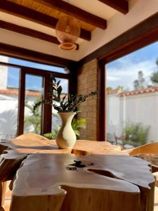 a wooden table with a vase on top of it at Hotel Alandalus in Villa de Leyva