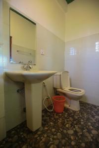 a bathroom with a sink and a toilet at Ella Nine Arch lodge in Ella