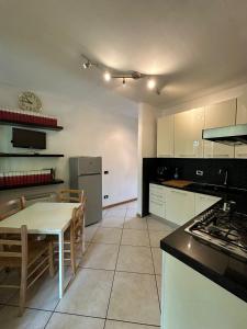 a kitchen with a table and a kitchen with a refrigerator at Vespucci Rooms & Apartament Eliana SELF CHECK-IN in Florence