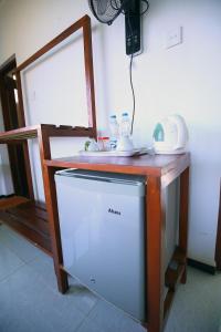 a kitchen with a counter with a dishwasher and a mirror at Ella Nine Arch lodge in Ella