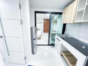 cocina con fregadero y nevera en S&Y Apartment en Ban Nong Waeng