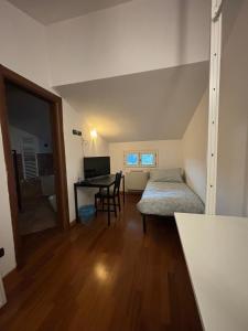 フィレンツェにあるVespucci Rooms & Apartament Eliana SELF CHECK-INのベッド、デスク、テーブルが備わる客室です。