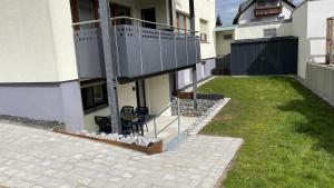 a house with a patio with chairs in the yard at Apartment Erbach-Ulm in Erbach