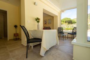a dining room with a table and chairs and a window at Hôtel Méditerranée in Le Lavandou