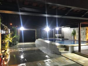 a pool in a house at night with lights at Beach House Ocean in Bertioga