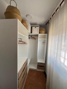 a walk in closet with white walls and a window at Apartamento en Las Negras in Las Negras