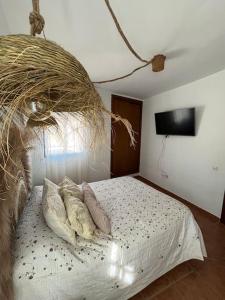 a bedroom with a bed with pillows on it at Apartamento en Las Negras in Las Negras