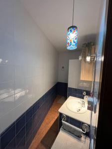 a bathroom with a sink and a blue tiled wall at Apartamento en Las Negras in Las Negras +3 photos