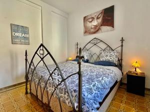 a bedroom with a bed with a blue and white comforter at El Rincon del Torcal in Villanueva de la Concepción