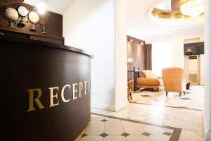 a reception area of a hotel lobby with a reception desk at Hotel Diplomat in Tbilisi City